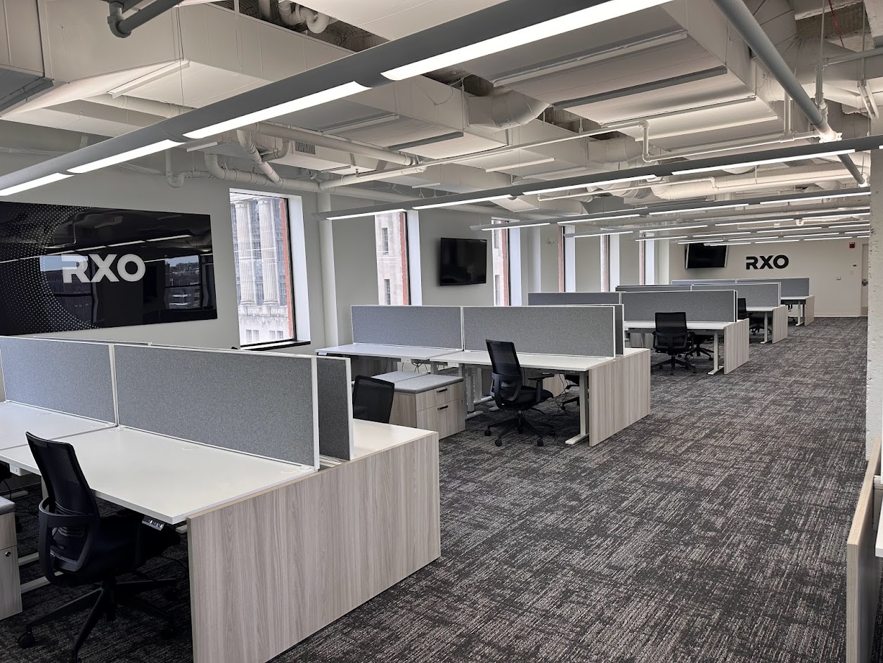 office with chairs, desks, and a television