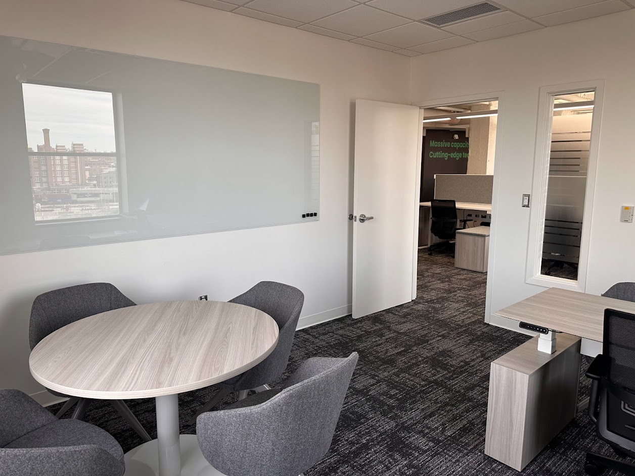 office with meeting table and board on wall